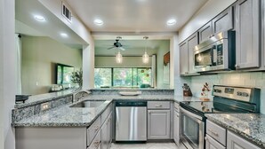 A modern kitchen with granite countertops, stainless steel appliances, and a dishwasher. - Quiet Beachside retreat w/ Golfcart included - close proximity to everything! (Miramar Beach)