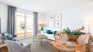 A modern living room with a sofa, chairs, a coffee table, and a dining table. - Genteel Home San Antonio Terrace II (Cadiz)