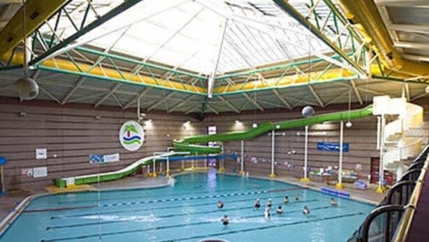 An indoor swimming pool with multiple lanes, a diving platform, and a water slide. - Lovely 2- Bed Apartment in Hawick (Hawick)