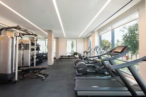 A modern gym with treadmills, weight machines, and dumbbells. - AC Hotel by Marriott Palo Alto (Palo Alto)