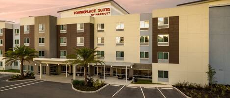 A multi-story hotel with a modern design, featuring a prominent sign for 'Townplace Suites by Marriott'.