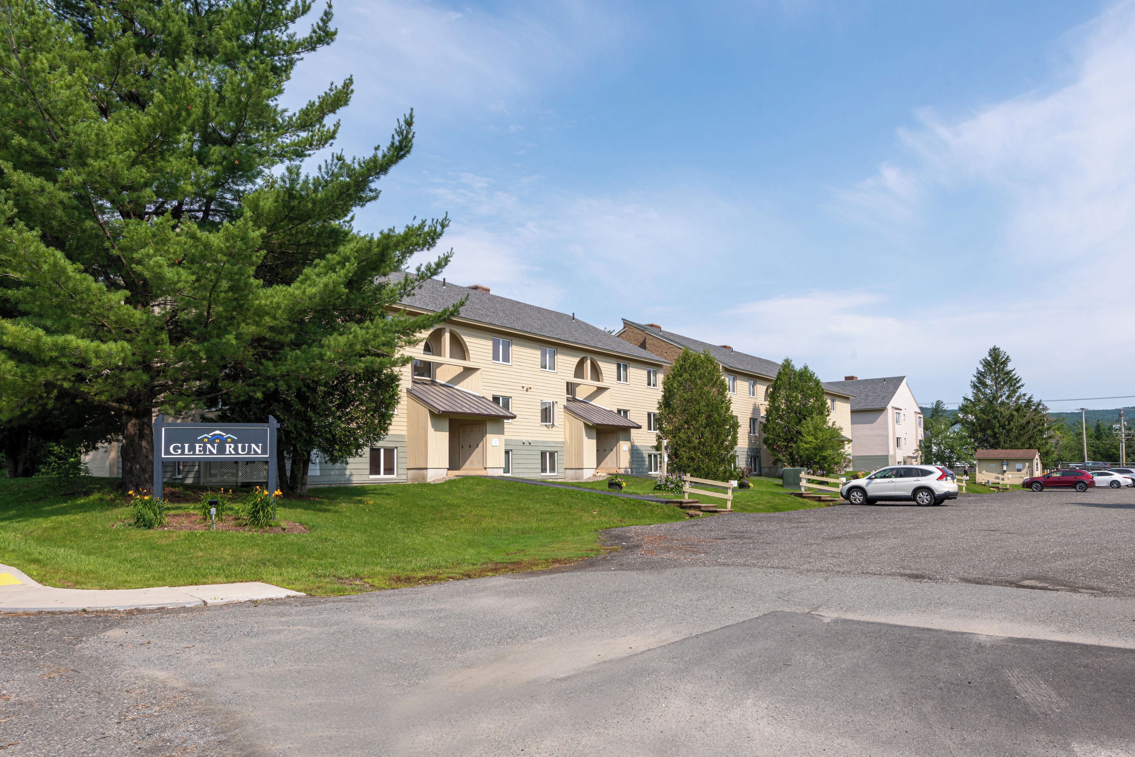 A multi-story residential building with a sign reading "Glen Run."