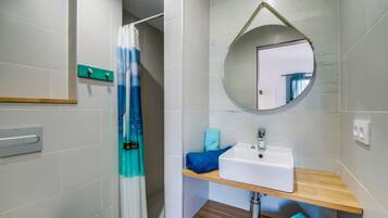 Shower, hair dryer, towels, toilet paper