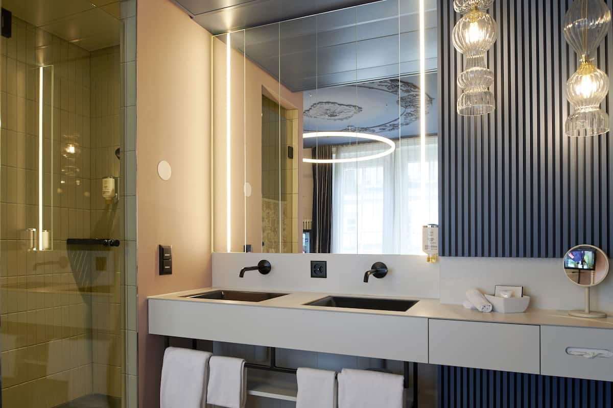 boutique pilatus suite | bathroom | shower, hair dryer, slippers, heated floors