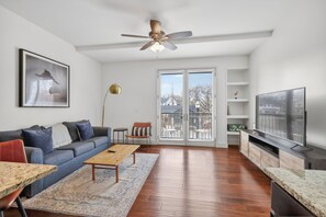 A modern living room with a sofa, coffee table, and TV.