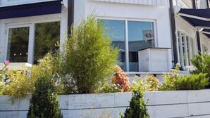 A building with a 'bartaco' sign, featuring a modern design with a flat roof and large windows. - Coffee Shops, Restaurants, Bars, Salons and Boutiques, just steps away. (Nashville)