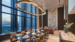 A modern dining area with a panoramic city view, a high ceiling with a unique light fixture, and traditional decor elements. - InterContinental Foshan Dongping Hotel by IHG (Foshan)