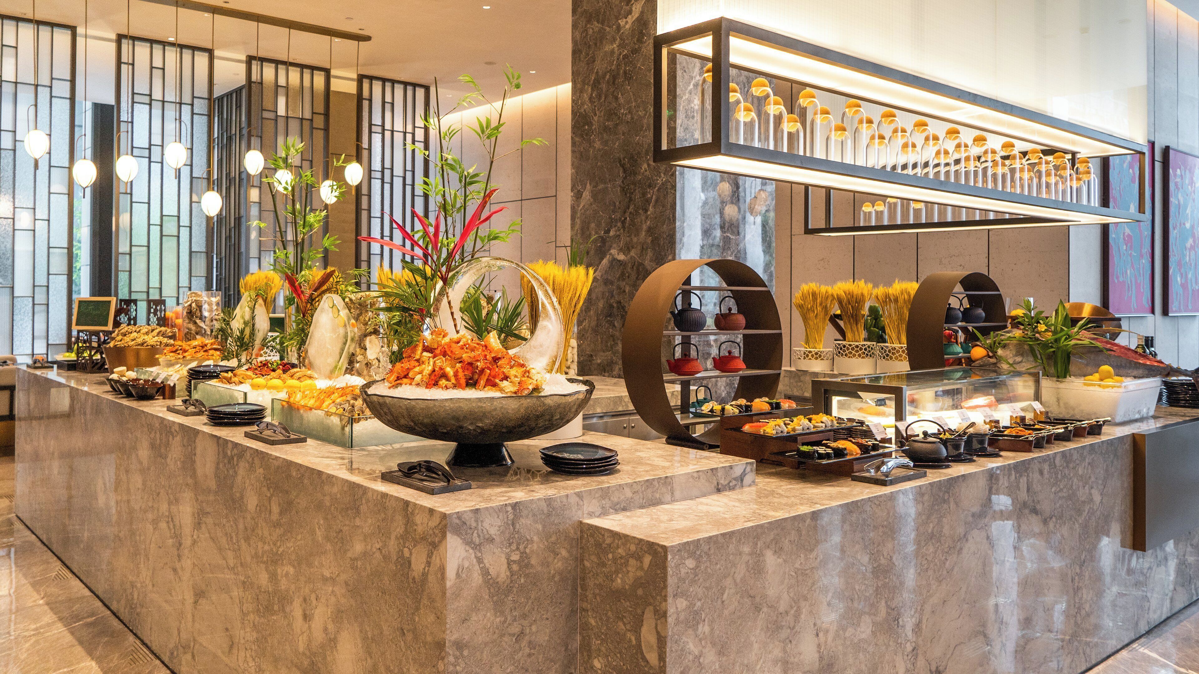 A buffet with various food items and a decorative centerpiece.