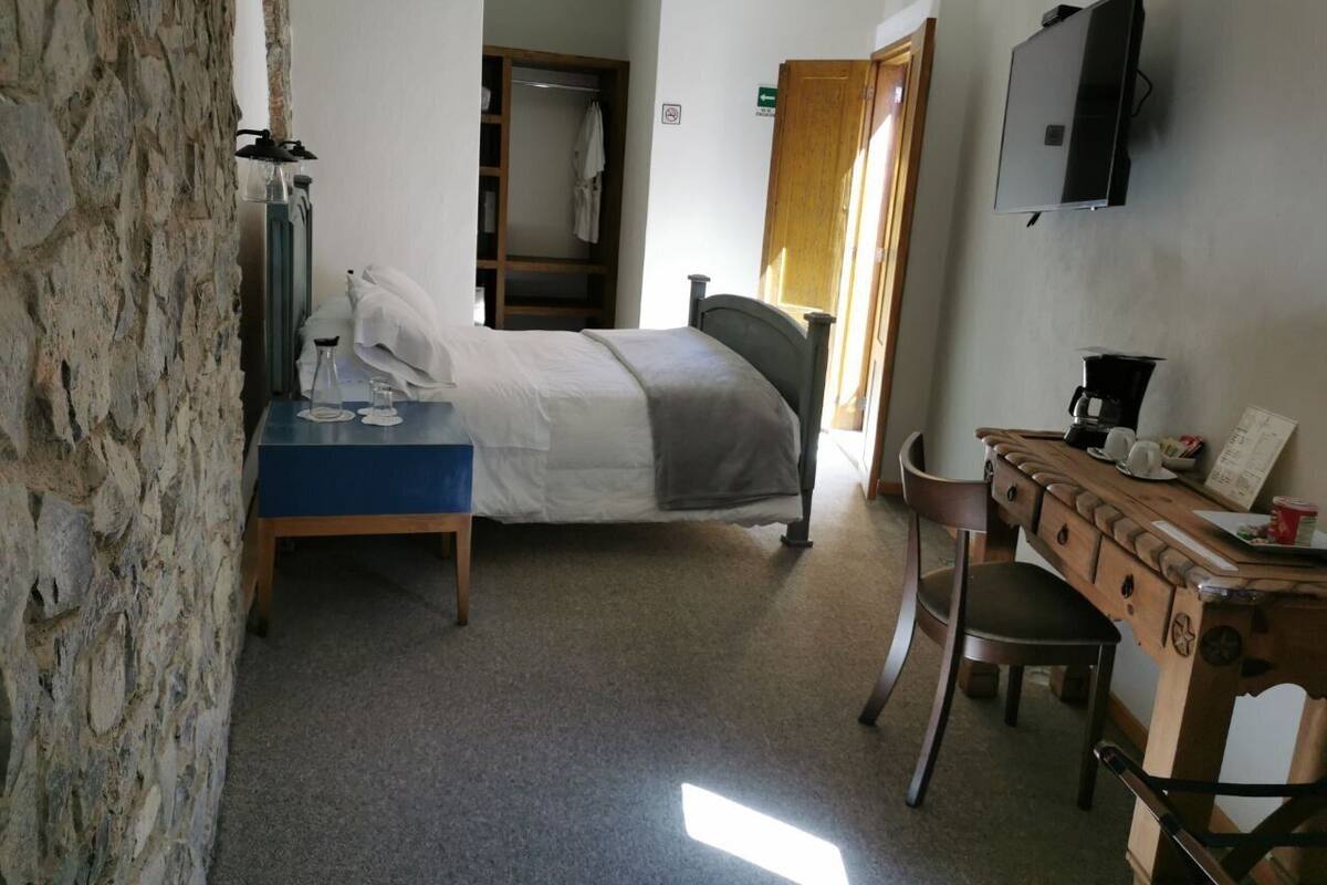 Habitación ejecutiva | Ropa de cama de alta calidad y edredones de plumas