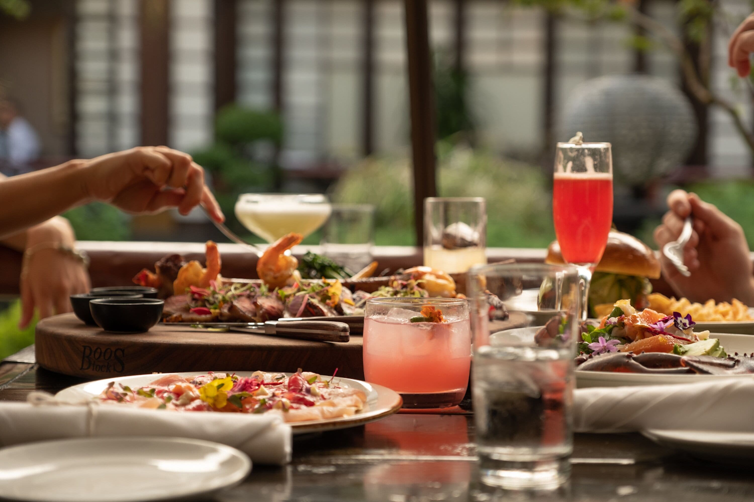 A dining table with various dishes, drinks, and utensils.