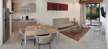 Um espaço de estar moderno com cozinha, sala de jantar e área de estar.