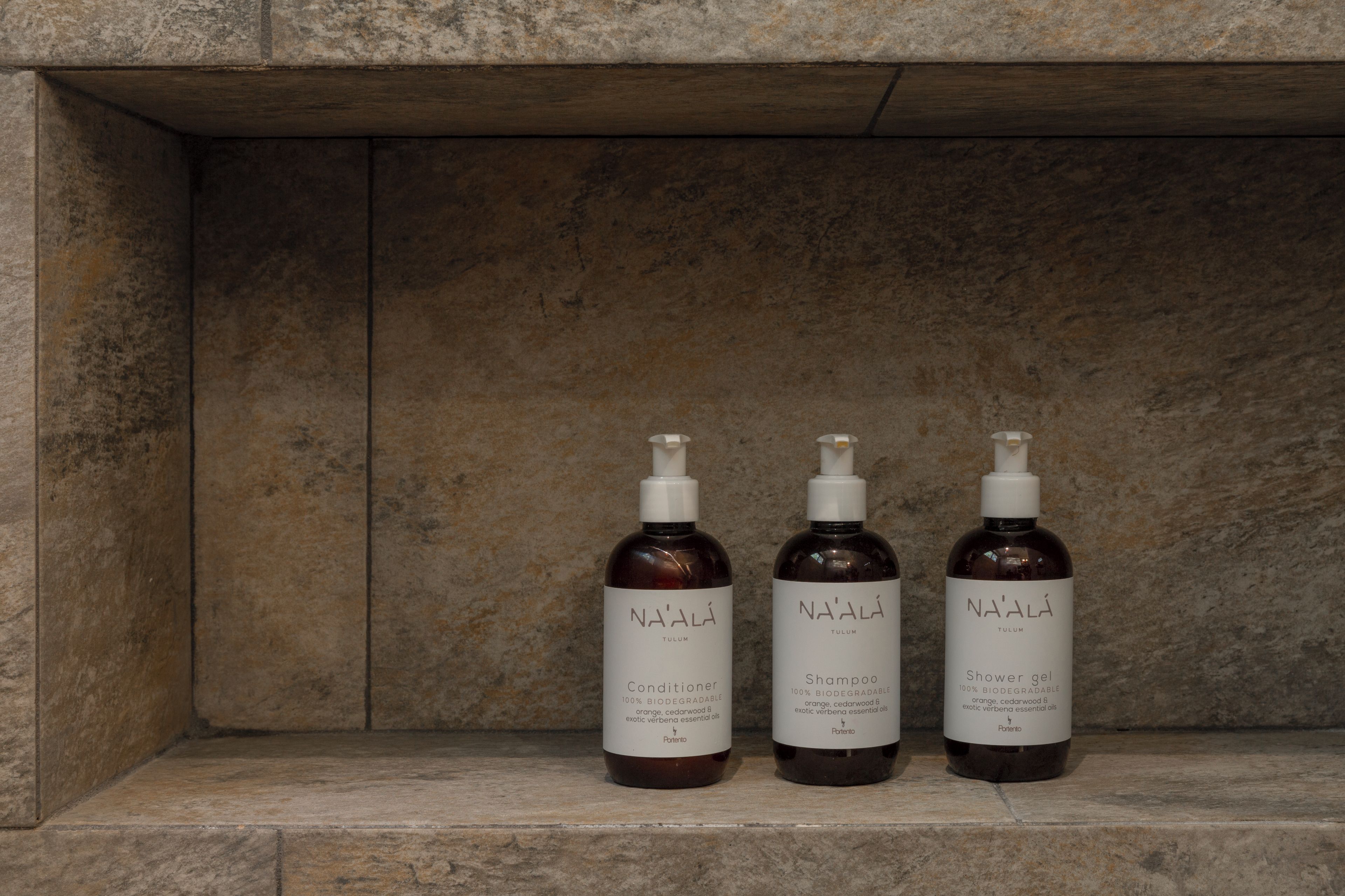 Three bottles of NA'ALI Tulum products on a shelf.