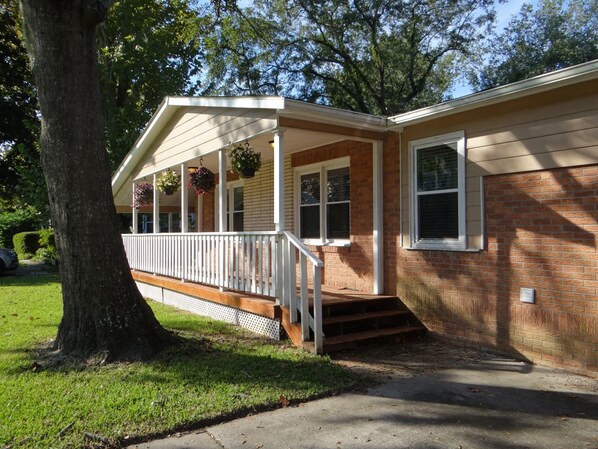 Stroll up to this charming single-story home with a cozy porch and beautiful flower baskets.