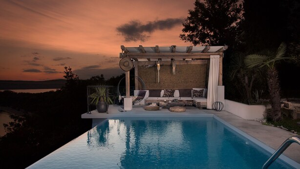 A poolside area with a pergola, lounge chairs, and a view of the landscape. - Villa Fun Haus 2 (Jadranovo)