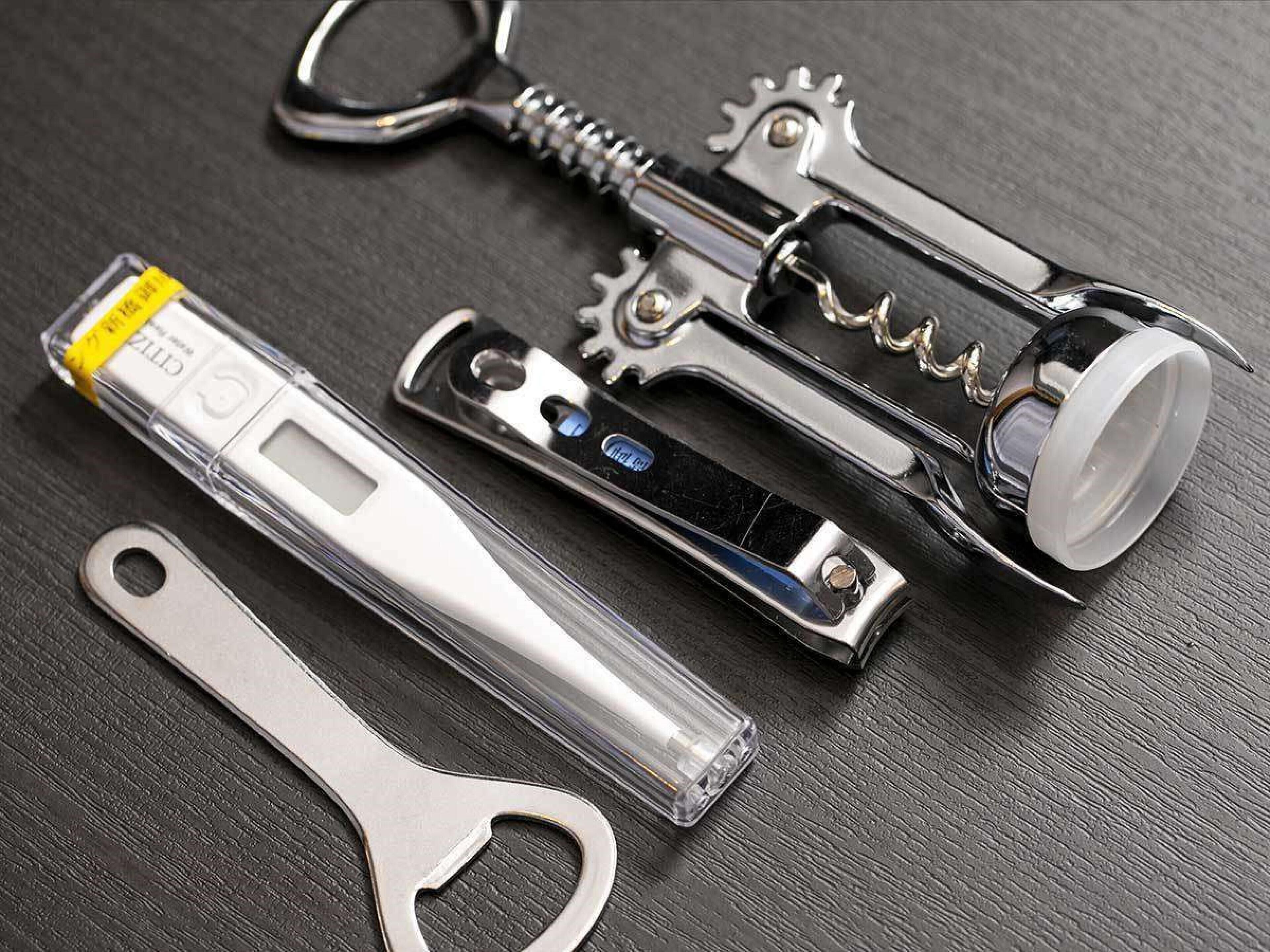 A collection of tools including a bottle opener, a lighter, and a bottle cap.