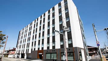 Hotel building with a striking vertical facade and a mix of dark and light panels.