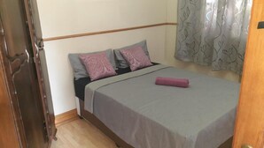 A bedroom with a bed, two pillows, a blanket, and a door. - Karl Heyne Guesthouse - Spacious Double Room (Rustenburg)
