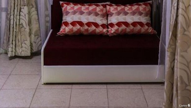 A room with a bed, curtains, and a patterned wall. - Bungalow in a Lovely Village Kamena (Petrich)