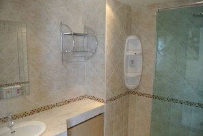 A bathroom with a sink, a towel rack, a shower, and a soap dispenser. - Baan Suan Lalana Tc Floor 5 Room (Pattaya)