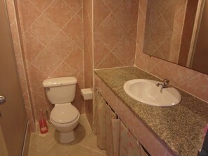 A bathroom with a toilet, sink, and mirror. - View Talay Condo 2A Floor 16 Room (Pattaya)
