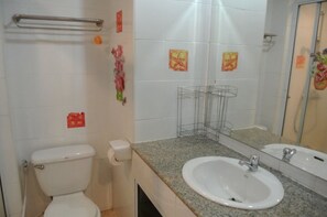A bathroom with a toilet, sink, and shower area. - View Talay 2A Floor 2 Room 5051 (Pattaya)