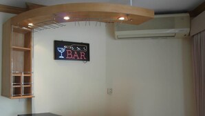 A bar area with a digital sign, wooden cabinets, and an air conditioning unit. - View Talay 1A Floor 4 Room (Pattaya)