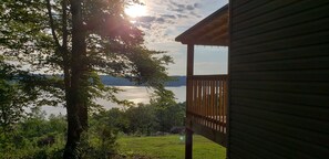 A wooden deck overlooking a lake with trees in the foreground. - Douglas Lake, TN Lake House, lake access, breathtaking views and amazing sunsets (Newport)