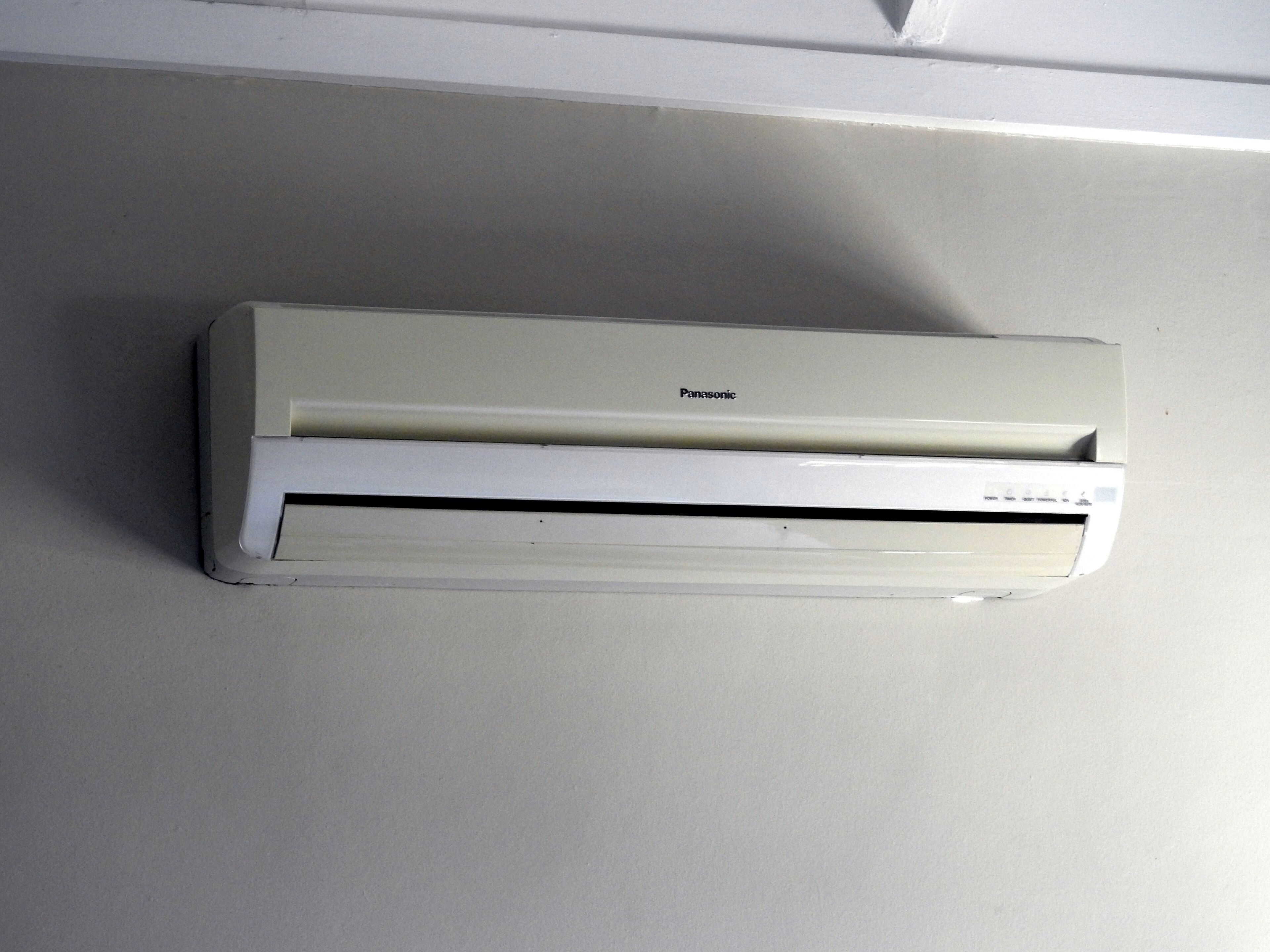 A white Panasonic air conditioner mounted on a wall.