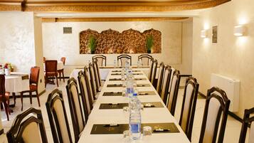 A conference room with a long table, chairs, water bottles, and nameplates.