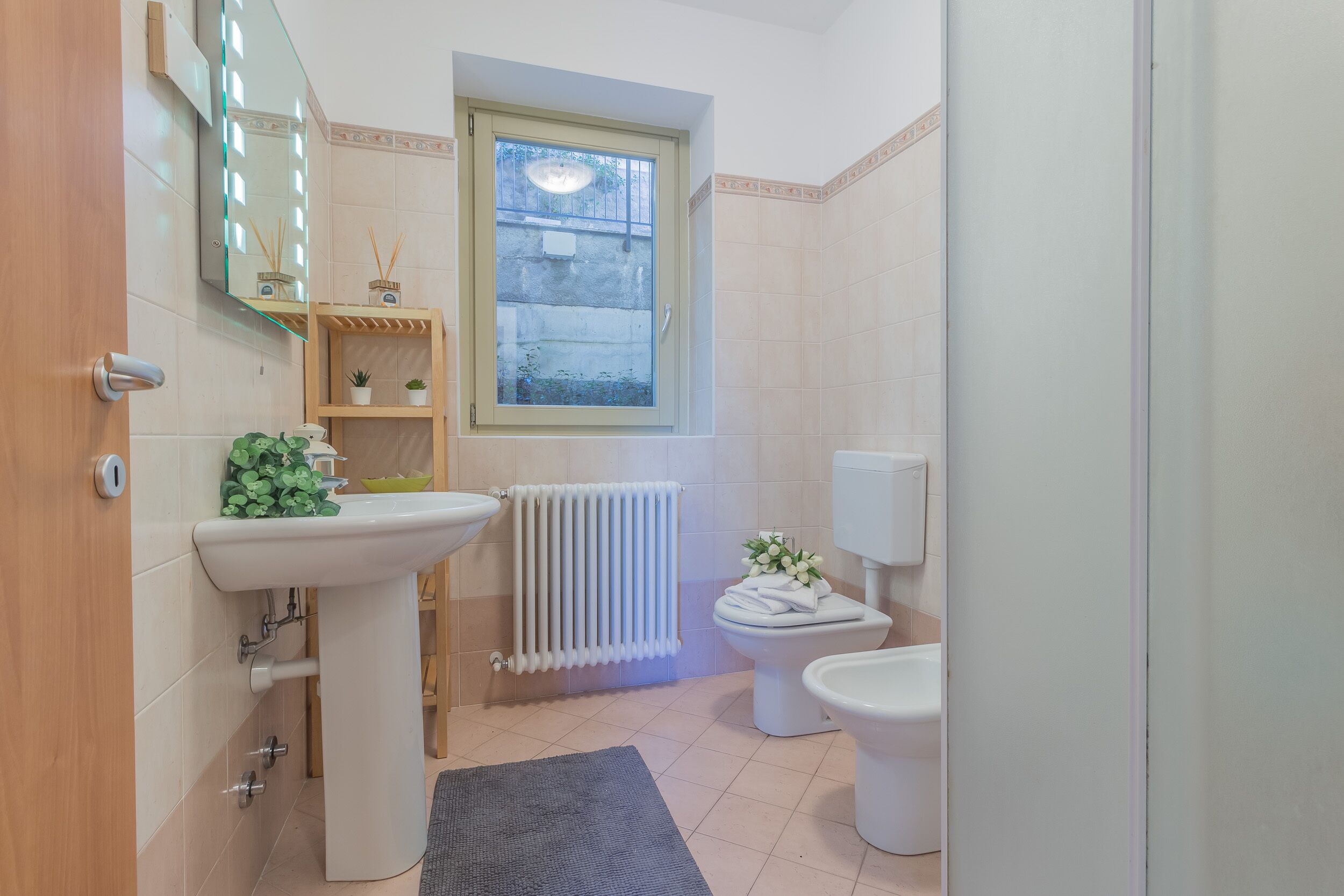 Un baño con lavabo, inodoro y ventana.