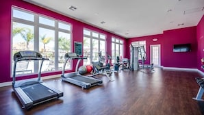 A gym with treadmills, elliptical machines, and weight equipment. - New listing  townhouse in gated community, sleeps 6. 10 min to Disney! (Kissimmee)