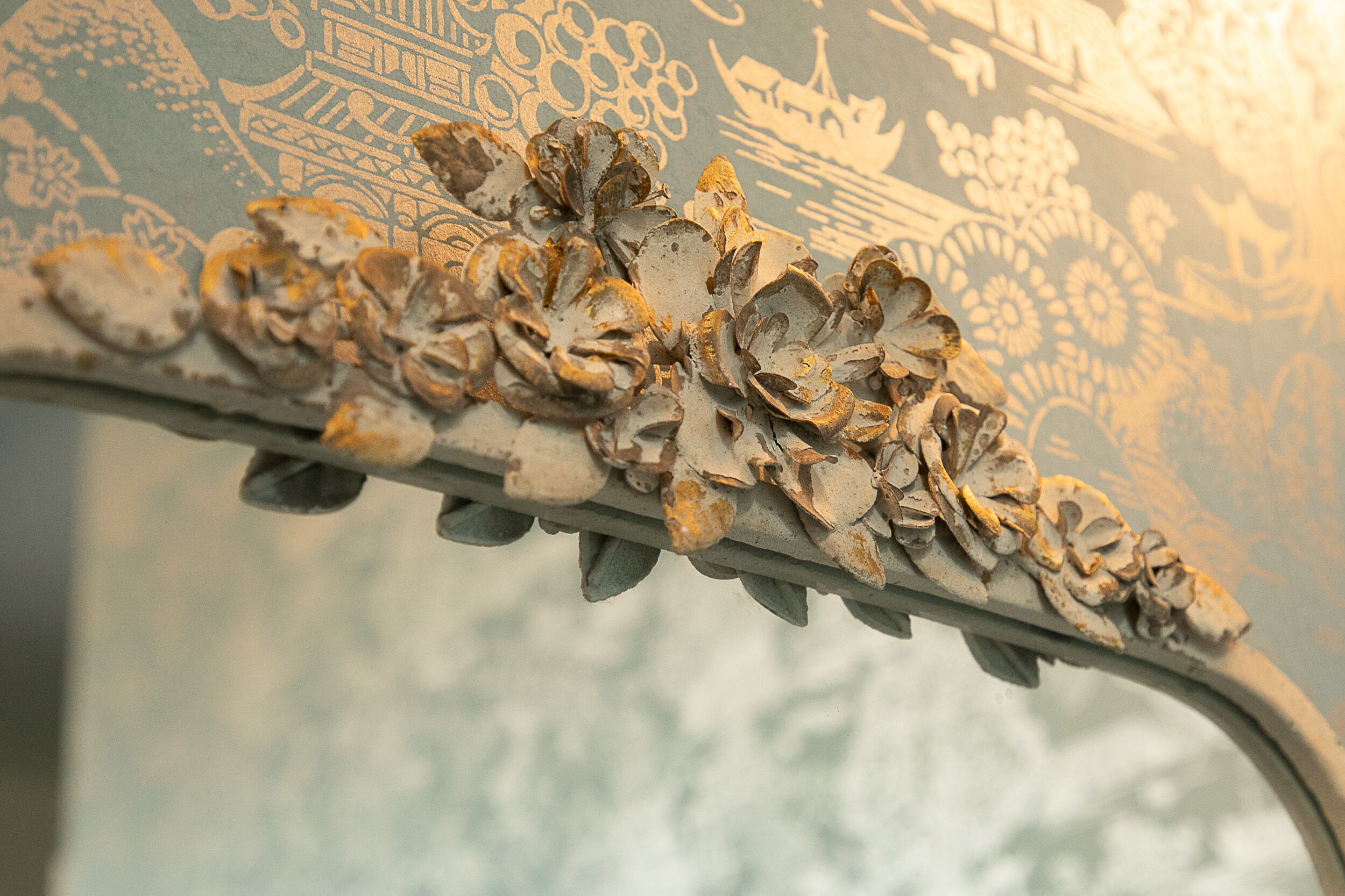 A close-up of a decorative metal trim with floral patterns.