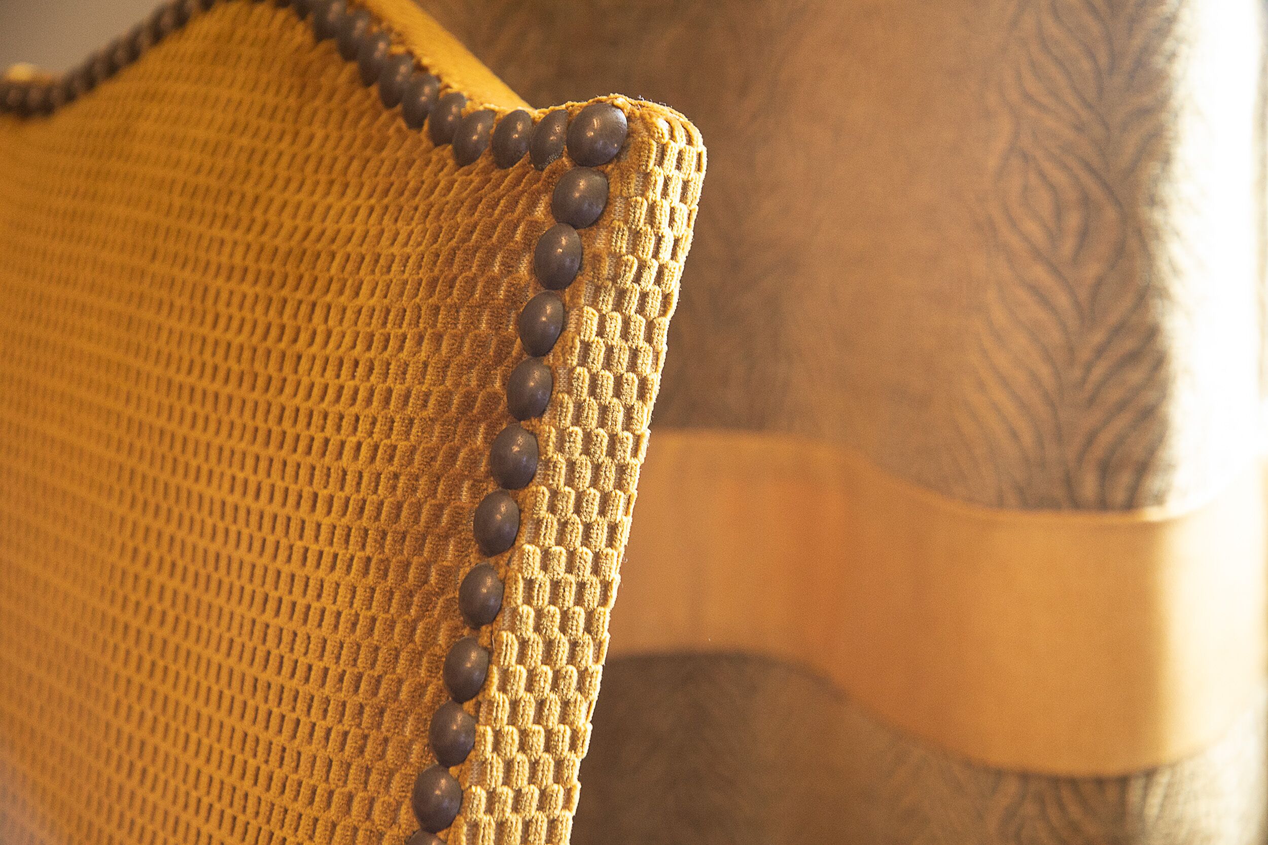 A close-up of a textured fabric with a beaded trim.