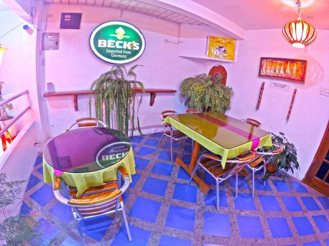 A dining area with a table and chairs, a grill, and a sign indicating the restaurant is imported from Germany.