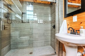 Bathtub, hair dryer, towels, shampoo