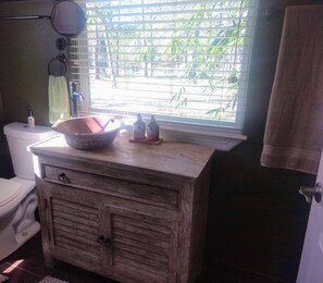 A bathroom with a wooden vanity, a large bowl, and a window with blinds. - West Wing at the Manor w/ Swimming Pond & Sand Volleyball Access (Montgomery)