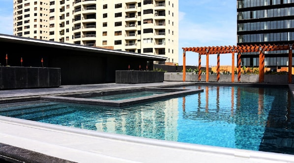 Outdoor pool, open 10:00 AM to 9:00 PM, pool umbrellas