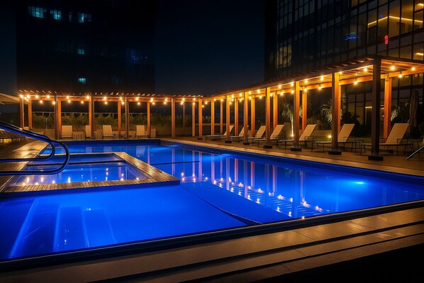 Outdoor pool, open 10:00 AM to 9:00 PM, pool umbrellas