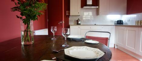 Enjoy meals with family and friends at this dining table for four, set amidst a stylish kitchen area.