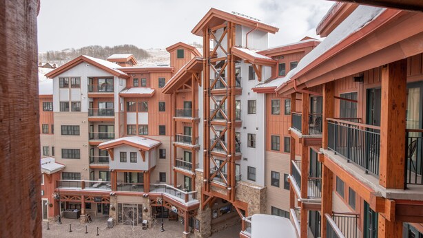 A multi-story hotel with a central atrium, balconies, and a ski lift structure. - Comfortable 1 Bedroom Slopeside Condo - No Cleaning Fee! by RedAwning (Crested Butte)