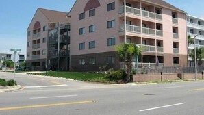 A multi-story hotel with balconies and a central staircase. - Just steps away from the beach!  (Myrtle Beach)
