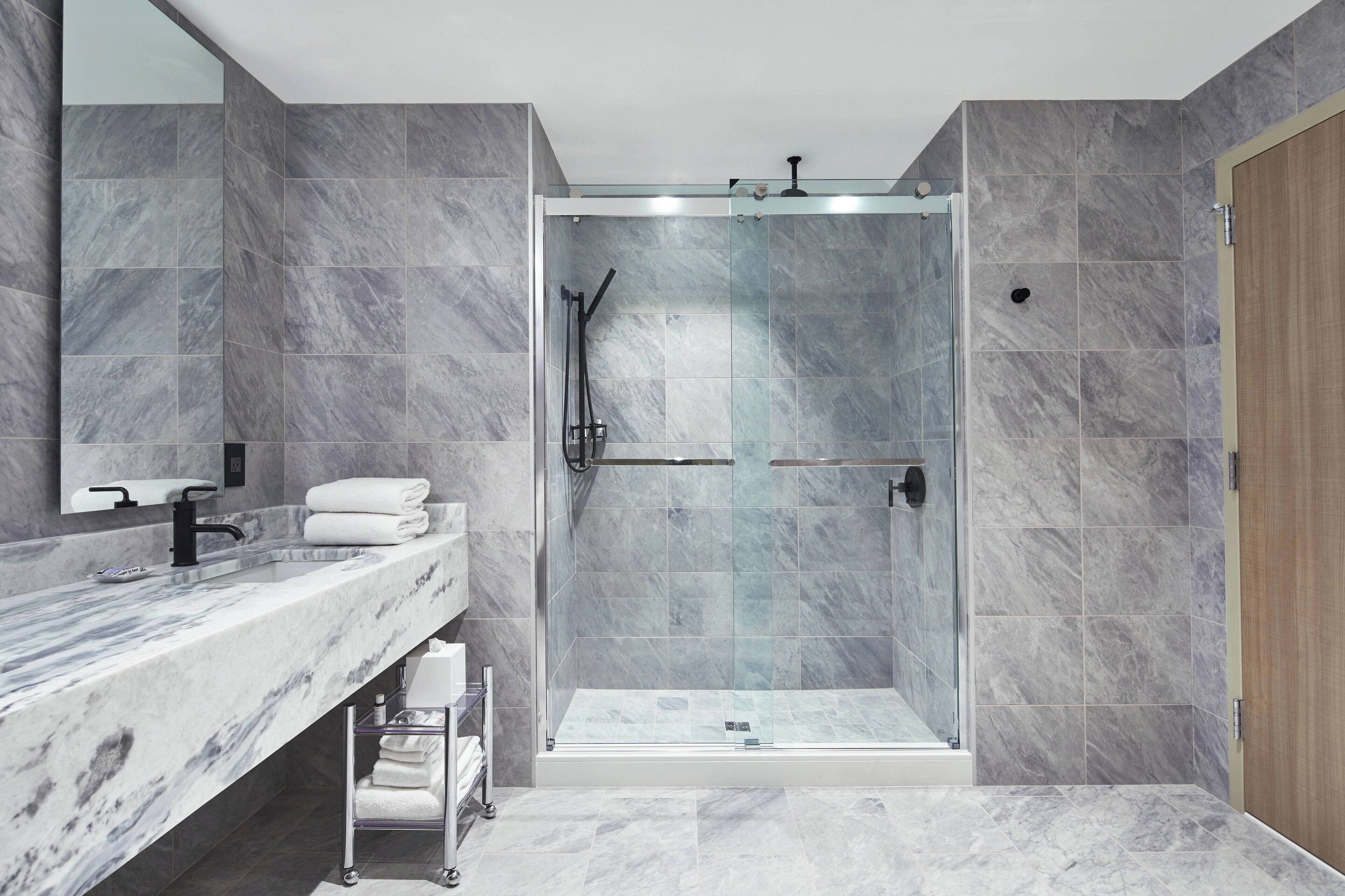 suite, 1 king bed with sofa bed | bathroom | shower, rainfall showerhead, eco-friendly toiletries, hair dryer