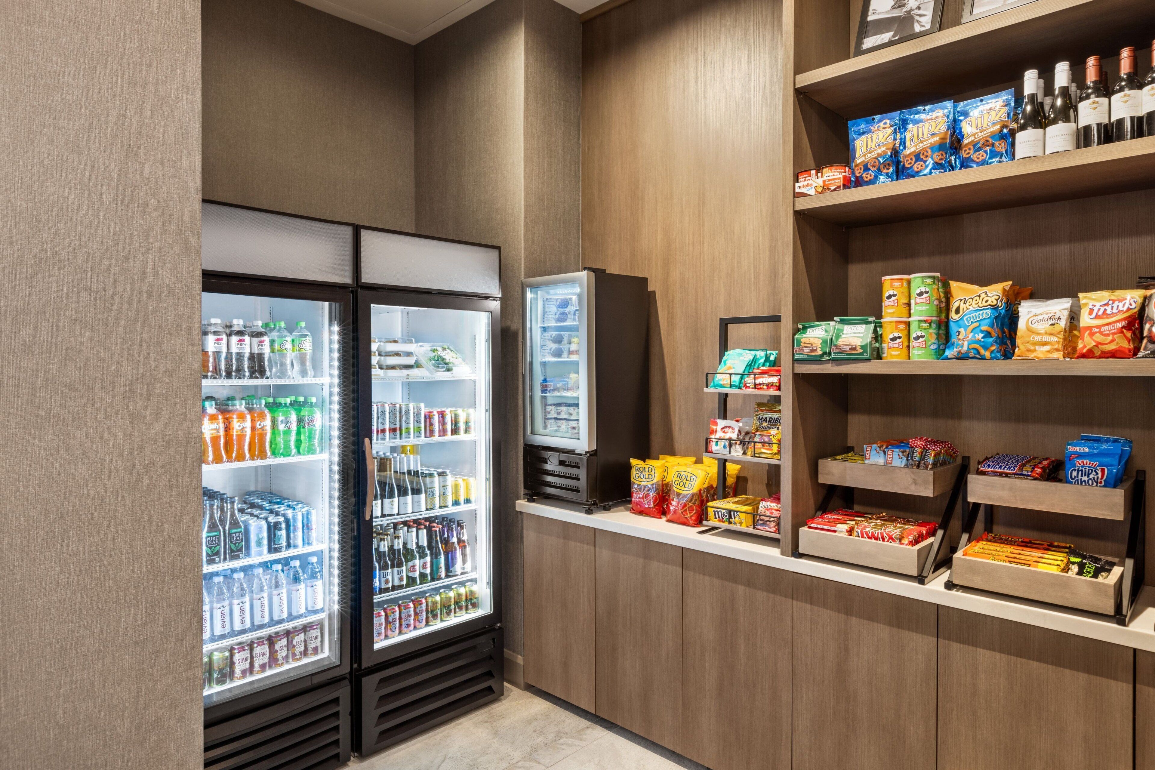 A self-service snack and beverage area with refrigerated drinks and snack options.