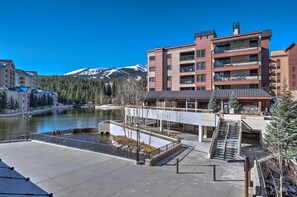 Ein modernes Hotel mit Seeblick und Bergblick. Es verfügt über einen zentralen Innenhof mit einem Brunnen, einen überdachten Gang und eine Treppe zu den oberen Stockwerken.