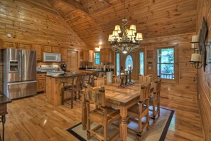 Enjoy family meals and gatherings around the large dining table in this well-equipped kitchen with a spacious island.