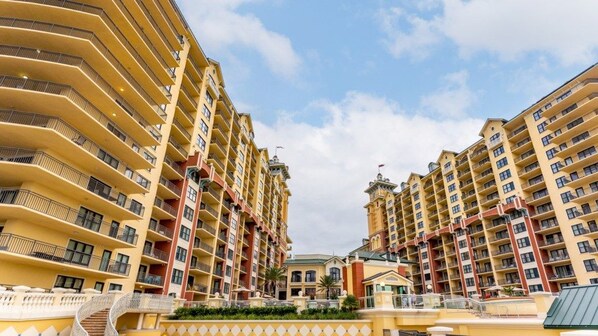 A multi-story hotel with balconies, a central courtyard, and a distinctive architectural design.
