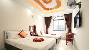 A hotel room with two beds, a desk, a chair, a TV, and a window with curtains. - Tuyet Minh Hotel (Ho Chi Minh City)