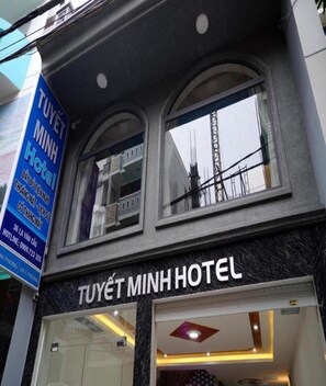 The exterior of Tuyet Minh Hotel with a clear view of the entrance and signage.