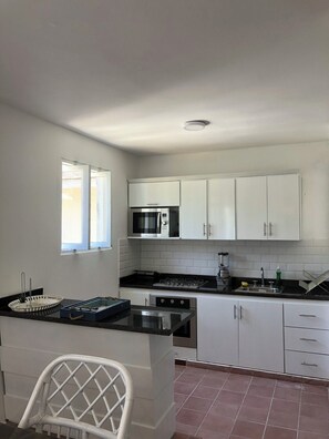 Microwave, coffee/tea maker, cookware/dishes/utensils