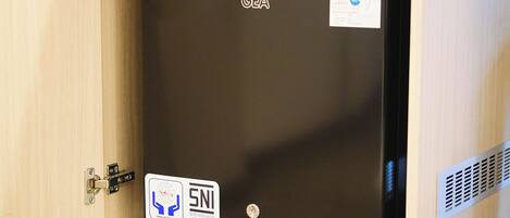 A GEA refrigerator with a GE logo and a SNI certification sticker.